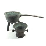 A bronze 18th century saucepan on three legs, 35cm long and a bronze mortar