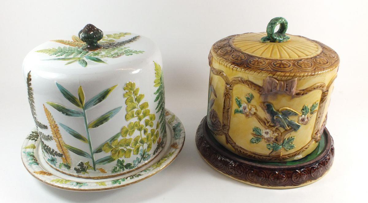 Two Victorian Majolica cheese domes, one marked Adderley with fern design and the other with flowers