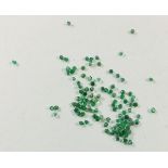 A group of 5 carats of 1mm round cut emeralds