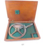A brass navigation tool by E R Watts & Son, in mahogany case