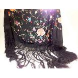 A black silk shawl with all over coloured embroidery