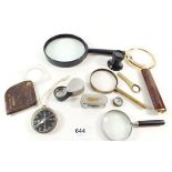 Eight antique and vintage magnifying glasses and two pocket compassses