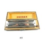 A Hohner harmonica cased