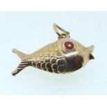 A 9 carat gold charm in the form of a fish, unmarked but tested, 1.4g