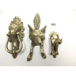 Three novelty brass door knockers in the form of a fox, lion and cat