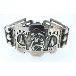 A Mexican silver hinged link bracelet with tongue and box clasp, the central panel embossed with