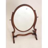 A small oval swing mirror