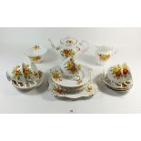 A Tuscan floral tea service comprising: six cups and saucers, teapot, jug and sugar and cake plate
