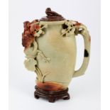 A Chinese carved soapstone or hardstone water pot with floral decoration and carved bird finial,