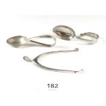A pair of wishbone form silver sugar pincers and two silver children's spoons, 53g