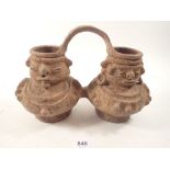 A Pre-Columbian pottery double figure form water vessel, 17cm tall