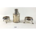 A silver cylindrical tea caddy 11cm tall and a pair of Georgian silver salts, marks rubbed and