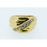 An 18 carat gold wide band ring set diagonal row of seven diamonds, size H, 5.3g