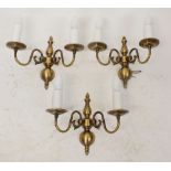 A set of three brass baluster wall lights