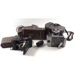 A Zeiss Icon folding camera Contessa Nettel, an Ensign Selfix camera and a Bell and Howell cine