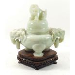 A carved green 'jade' pot and cover with dog of fo finial and shoulders, 18cm tall with stand