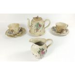 A Japanese early Satsuma part tea service decorated in famille rose pallette comprising: teapot,