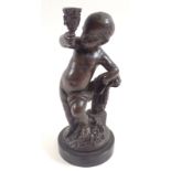 A 19th century bronze of a putti with torchere 16cm including marble base