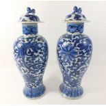 A pair of Chinese vases and covers painted Persian style floral decoration, 31cm high with lid