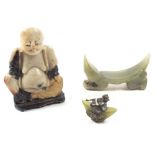 A Chinese jade carved arm rest, a jade and white metal lion miniature and a soapstone buddha