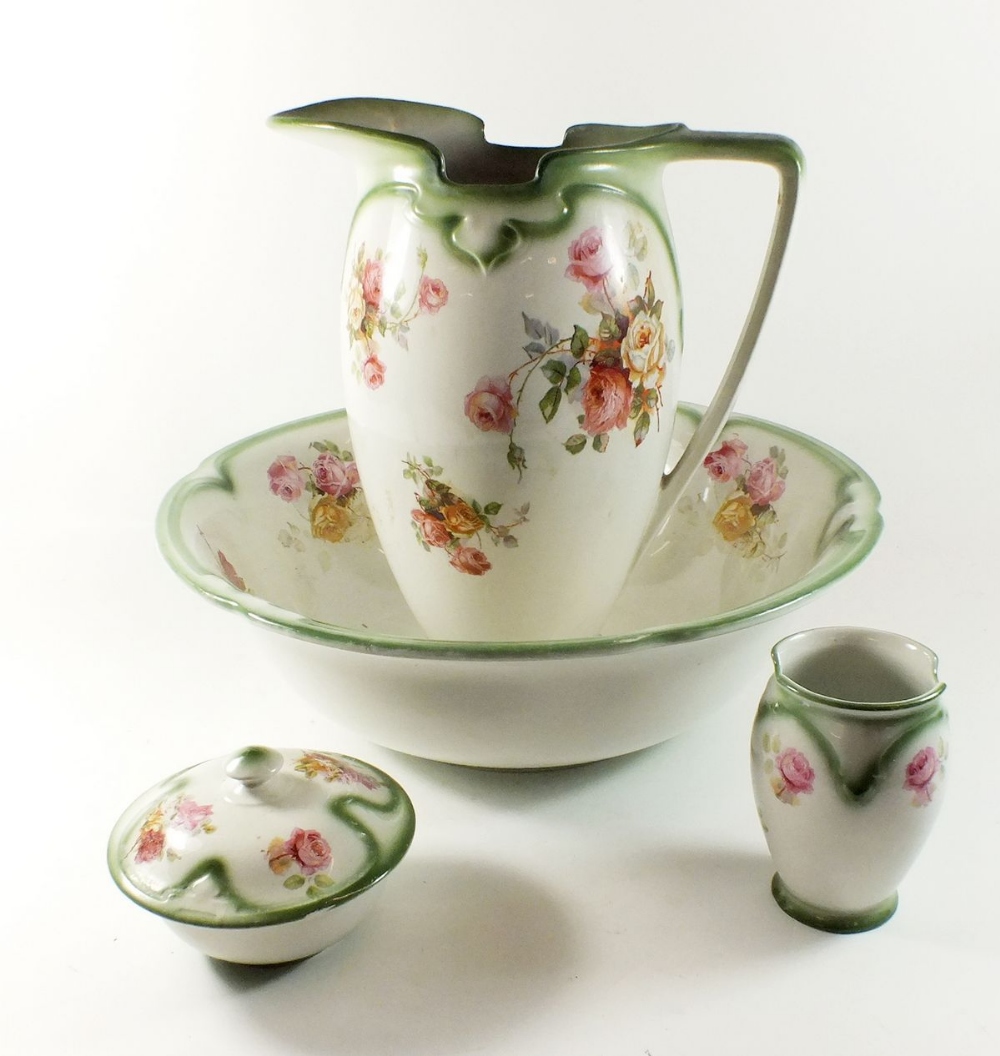 A Burleighware toiletry set comprising jug and bowl, toothbrush mug and soap dish - printed flowers