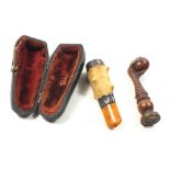 A painted bronze claw and ball form seal and a silver mounted meerschaum cheroot holder cased