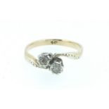 An Edwardian 9 carat gold crossover ring illusion set two white stones , size L, 2.1g
