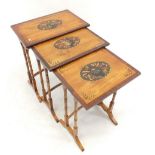 A nest of three satinwood and rosewood occasional tables painted musical motifs