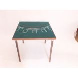 A folding card table with baize top