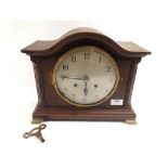 An oak arch mantel clock