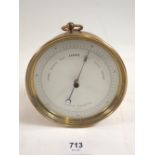 A brass aneroid ships barometer, 12cm diameter