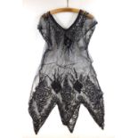 A 1920's black sequin and net flapper dress and a brown lace fringed one plus a pair of 1940;s