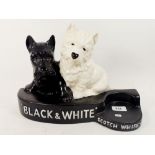 A Brentleighware 'Black and White Scotch Whisky' advertising bar stand with two terriers, 36 x 24cm