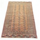 A Turkoman style rug with three rows of guls on a claret colour ground, 130 x 190cm