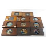 Eleven wooden framed magic lantern slides, mainly hand painted coloured scenes, but also one