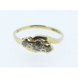 A 9 carat gold three stone crossover diamond ring, size O to P