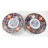 A pair of 19th century Japanese Imari dishes with floral decoration, 33cm diameter