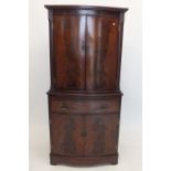 A reproduction mahogany drinks cabinet with two doors over drawer and cupboard