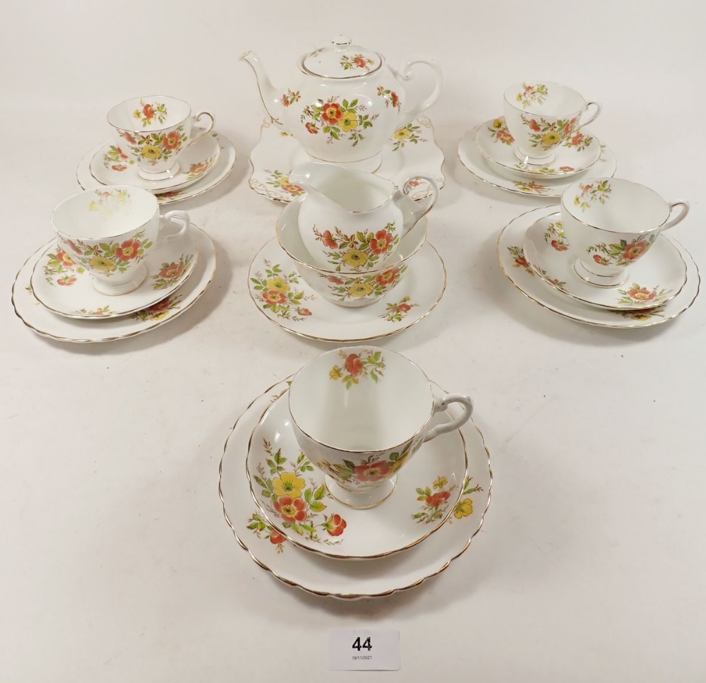 A Tuscan floral tea service comprising: six cups and saucers, teapot, jug and sugar and cake plate