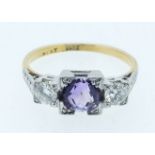An 18 carat gold and platinum Art Deco ring set amethyst flanked by two diamonds, size M