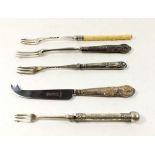 Four pickle forks and one silver handled cheese knife