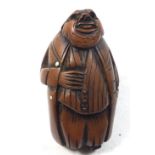 A Victorian snuff box in the form of an old man, his tail coat forming the hinged lid