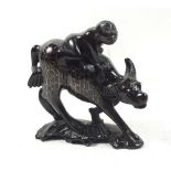 A 19th century 'Monkey and the Water Buffalo' Chinese wood carving with white metal inlay, 13cm tall
