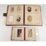 Two photograph albums containing a quantity of 19th century family photographs etc plus family crest