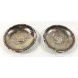 A pair of sterling silver Chinese pin dishes decorated with dragons and inset Chinese coins Kwang