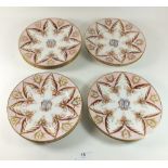 A set of nine 19th century tea plates painted in pink and gilt with monogram to centre