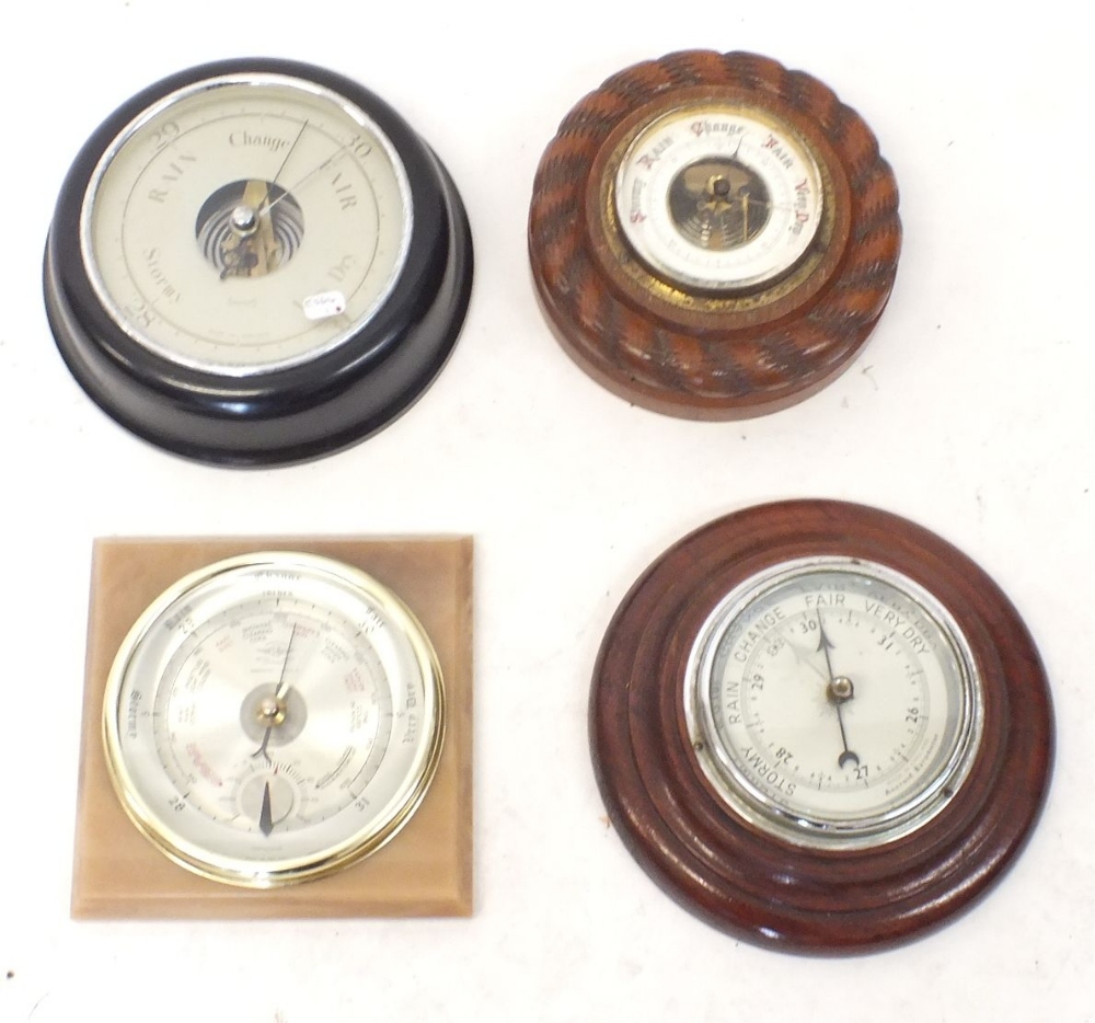 Four various barometers including a Smiths Bakelite one and carved rope border one