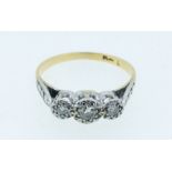 An early 20th century 18 carat gold and platinum set three stone diamond ring, size K to L, 2g
