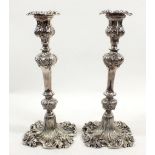 A pair of silver plated foliate clad candlesticks, 28cm
