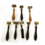 Eight various powder shot measures in brass and steel with ebony, beech and fruitwood handles by Haw